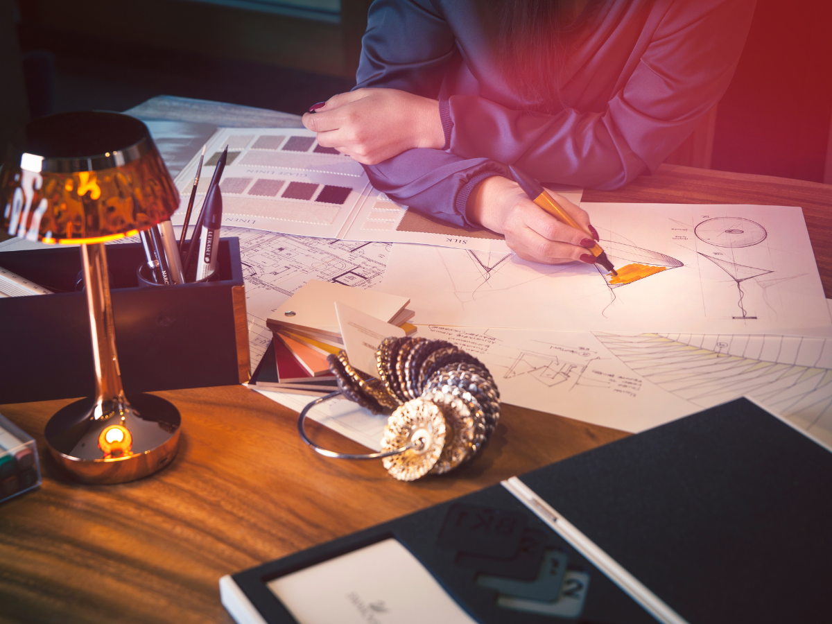 Lighting design in the making: sketches, floor plan and material samples on the worktable